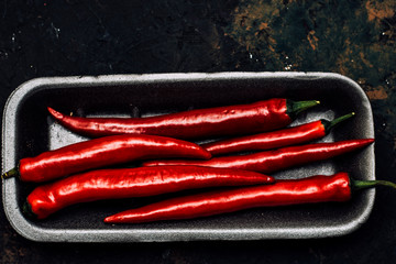 Naklejka premium Red pepper on black background.Spicy.Food concept.Top view.Vegetable menu.To describe spicy dishes.Hot offer.Сhili flat lay.Mexican food