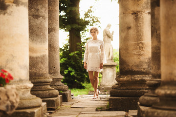 Fototapeta na wymiar A wonderful love story. Young couple walking around the old architectural columns