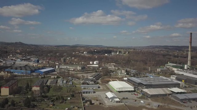 Gorlice, Poland - 3 9 2019: Industrial region of the Carpathian city. Top view of the refinery and auxiliary buildings. Video shot by drone or quadrocopter. Vanity of the day at the factory. Planning 