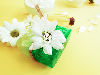 soap, oil, flower chrysanthemum on a yellow background