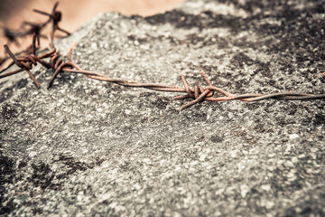 Barbed wire on old stone
