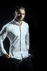 Handsome guy fashion. Muscular handsome guy on black background wearing elegant white shirt and black trousers. Dress code for work. Casual clothes for office workers, managers or businessmen