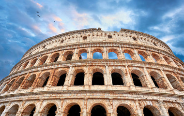 Colosseum (Coliseum or Colosseo) in Rome, Italy. Ancient ruins of Flavian Amphitheatre. Arena for gladiator fightings. World famous landmark and very popular touristic destination for vacation trip.