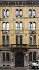 Fototapeta na wymiar old yellow building facade milan
