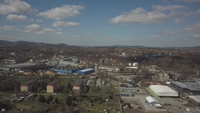Gorlice, Poland - 3 9 2019: Industrial region of the Carpathian city. Top view of the refinery and auxiliary buildings. Video shot by drone or quadrocopter. Vanity of the day at the factory. Planning 