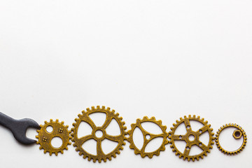 Top closeup view of gear wheels collection on white background with blank space for text. Top view, flat lay.