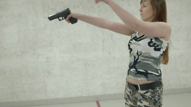 Slow Motion -Young Girl Aiming Gun