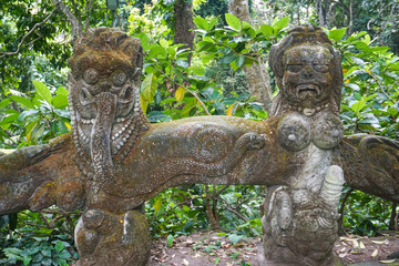 The statue in Ubud Monkey Forest covered by moss, Bali Island, Indonesia