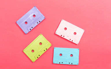 Retro cassette tape on a pink paper background