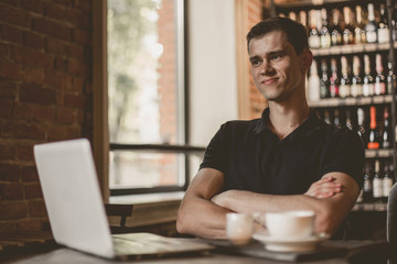 Businessman working on a laptop in a cafe.