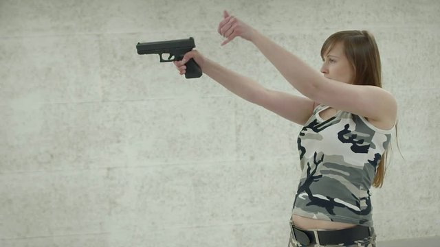 Slow Motion -Young Girl Aiming Gun