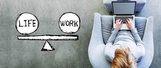 Life and work balance with man using a laptop in a modern gray chair