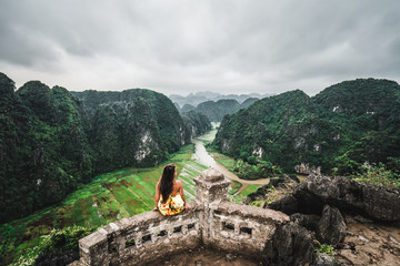 A woman overlooks the mountains of northern Vietnam from Hang Mua, a popular hiking destination.  