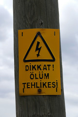 Turkish "attention danger of death" warning sign, hanging on mast,