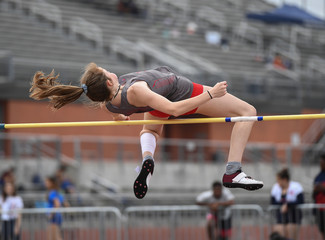 Young girls jumping high for a high jump track meet