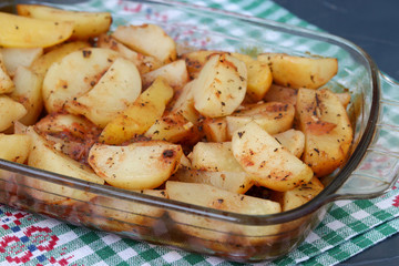 Baked Potatoes in glass form against dark background
