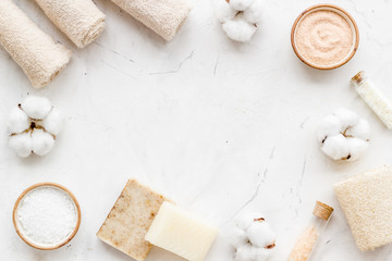 Zero waste set with cosmetics for spa and cotton materials on white background top view copyspace