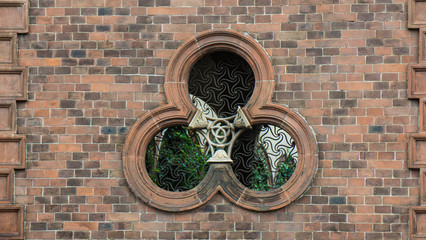 Fototapeta na wymiar round window on building facade of church