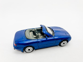 Blue toy convertible car on white background