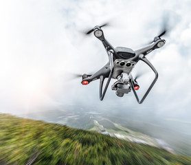 Modern drone flies in the mountains. Dark drone in the air against the backdrop of a mountain...