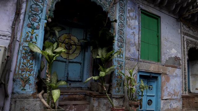 tilt up shot of a sleeping dog and an ancient door at naughara in the chandni chowk district of old delhi, india