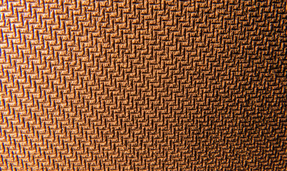 The close-up photo of a textured rubber surface in the warm light of a lamp.