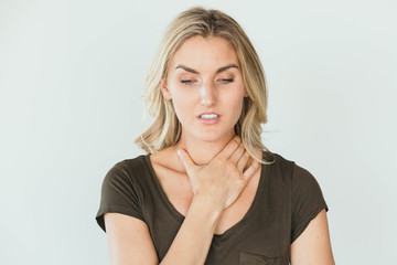 Caucasian blonde woman having a sore throat