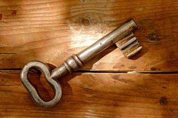 Old key on a wooden background