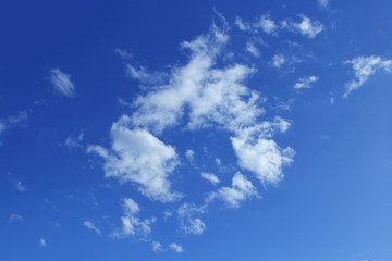 Naklejka na ściany i meble Fluffy white clouds on the blue color sky background