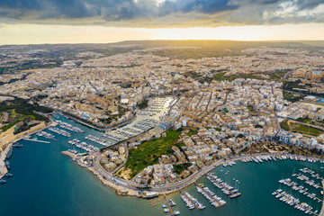 Fototapeta premium Aerial view of Manoel island and Gzira. Sunset time and clouds. Malta Island