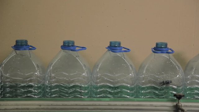 Plastic bottle manufacturing line. Plastic molding bottling factory. Blanks of plastic bottles in the factory.