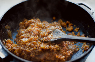 Kitchen with hot meals, and beans or lentils on big pan. Spicy food ready for eating