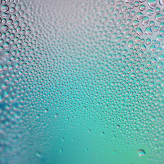 water drops on misted glass blue-violet macro