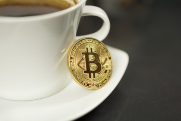 Bitcoin cryptocurrency coin with coffee cup and coffee beans