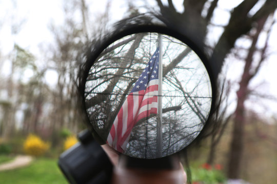 US flag under a rifle scope