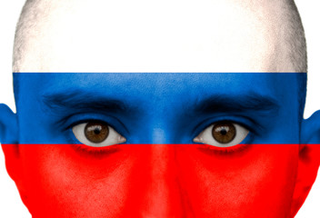 National flag Russia colored depicted in paint on a man's face close-up, isolated on a white background