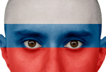National flag Russia colored depicted in paint on a man's face close-up, isolated on a white background