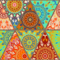  Seamless pattern - patchwork made up of triangular elements. Bright background and mandalas - round lace patterns, in green, red and yellow colors. The shreds are separated by a beige stripe.