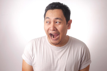 Fototapeta na wymiar Funny Asian Man Laughing