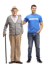 Young volunteer helping an elderly man with a cane