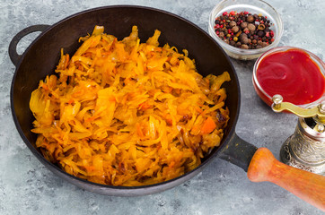 Pan with stewed sauerkraut.  Photo