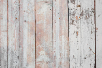 Fototapeta premium The texture of the old shabby fence of painted white paint boards