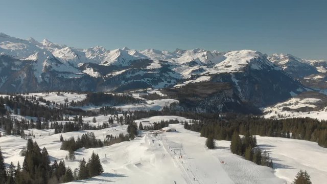 Beautiful winter landscape. People skiing in Mythenregion ski resort, Ibergeregg, Switzerland, Europe.