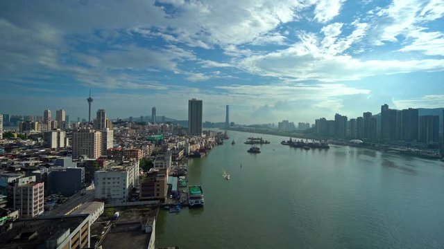 Pan from Pearl River delta under ar bright blue cloudscape  to the  Macau skyline, Macau,China