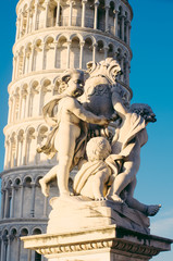 Fototapeta na wymiar Fontana dei Putti and Leaning Tower of Pisa