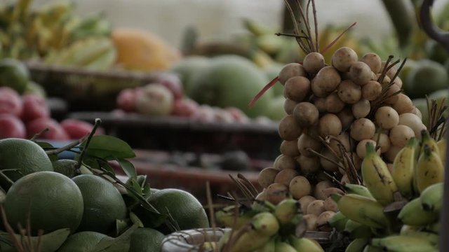 Fresh fruits from banana, lemon, langsat (lansium parasiticum), and more from local farmers in traditional floating market of Banjarmasin, South Kalimantan / Borneo, Indonesia. 4K UHD.