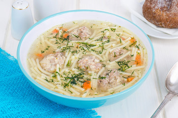Delicious broth with meatballs and pasta.