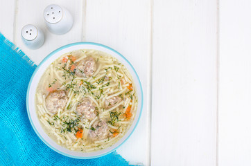 Delicious broth with meatballs and pasta.