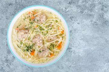 Delicious broth with meatballs and pasta.