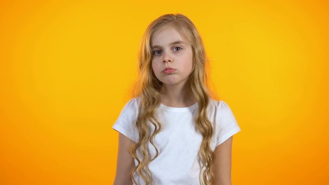 Girl making facepalm gesture and frowning, poor quality, naughty child, conflict